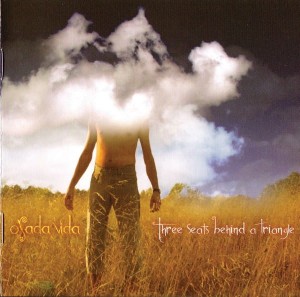 OSADA VIDA - THREE SEATS BEHIND A TRIANGLE (REMASTERED)